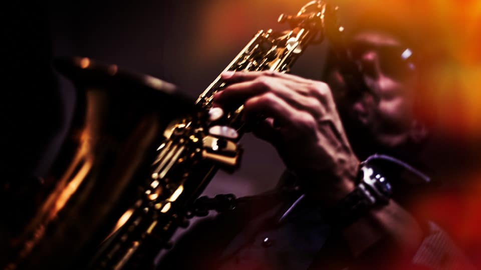 a man playing jazz on a saxophone
