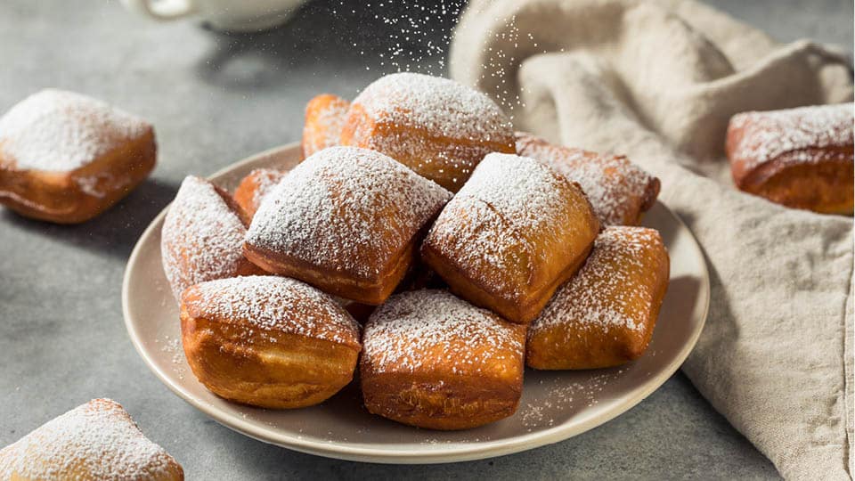 beignets covered in powdered sugar