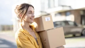 woman holding boxes to store with Mini Mall Storage